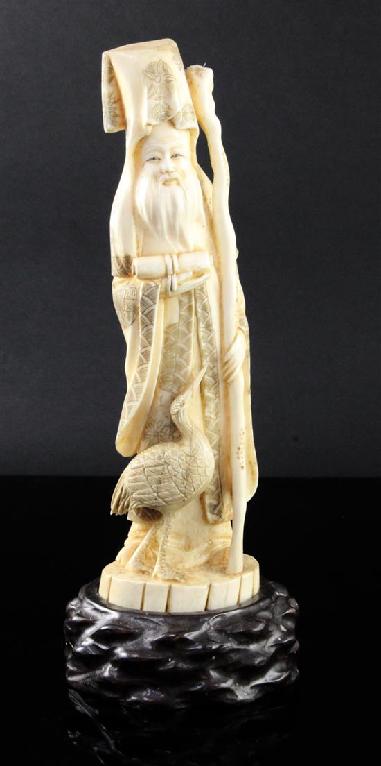 A Japanese walrus ivory figure of Fukurokuju, early 20th century, height 24.5cm incl. wood stand